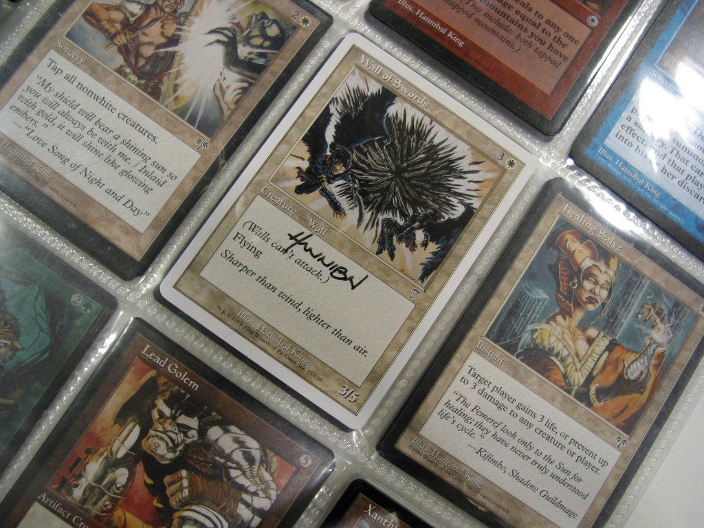 Artist proofs bearing King’s signature are seen in a binder. King illustrated 27 cards for Magic: The Gathering.
